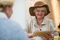 Senior woman with tablet smiling.