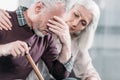 Senior woman taking care of husband with strong headache Royalty Free Stock Photo