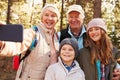 Senior woman taking outdoor selfie with grandkids and spouse Royalty Free Stock Photo