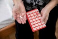 Senior Woman Taking Prescription Medicine and Organizing Pill Box