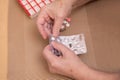 Senior Woman Taking Prescription Medicine and Organizing Pill Box