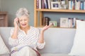 Senior woman talking on mobile phone while looking documents Royalty Free Stock Photo