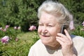 Senior woman talking on mobile phone outdoors Royalty Free Stock Photo