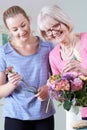 Senior Woman With Teacher In Flower Arranging Class Royalty Free Stock Photo