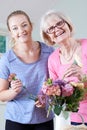 Senior Woman With Teacher In Flower Arranging Class Royalty Free Stock Photo