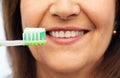 Senior woman with toothbrush brushing her teeth Royalty Free Stock Photo