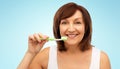 Senior woman with toothbrush brushing her teeth Royalty Free Stock Photo