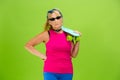 Senior woman in ultra trendy attire isolated on bright green background