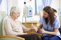 Senior Woman Undergoing Chemotherapy With Nurse