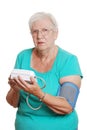 Senior woman use automatic blood pressure machine