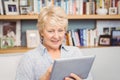 Senior woman using digital tablet at home Royalty Free Stock Photo