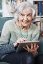 Senior Woman Using Digital Tablet At Home Royalty Free Stock Photo