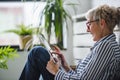 Smiling beautiful senior woman using digital tablet at home Royalty Free Stock Photo