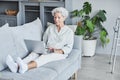 Senior Woman Using Laptop on Couch Royalty Free Stock Photo