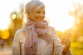 Senior woman using mobile phone outdoors in autumn Royalty Free Stock Photo