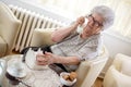 Senior woman using rotary phone at home Royalty Free Stock Photo