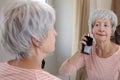 Senior woman using some delicious perfume Royalty Free Stock Photo