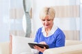 Senior woman using tablet computer at home Royalty Free Stock Photo