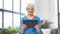 Senior woman using tablet computer at home Royalty Free Stock Photo