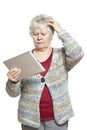 Senior woman using tablet computer looking confused Royalty Free Stock Photo