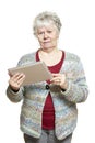 Senior woman using tablet computer looking confused Royalty Free Stock Photo