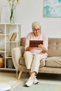 Senior Woman using Tablet at Home Full Length Royalty Free Stock Photo