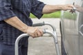 Senior woman using a walker at car park Royalty Free Stock Photo