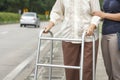 Senior woman using a walker cross street Royalty Free Stock Photo