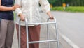 Senior woman using a walker cross street with caregiver Royalty Free Stock Photo