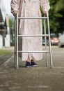 Senior woman using a walker on street. Royalty Free Stock Photo