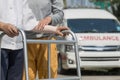 Senior woman using a walker to take ambulance Royalty Free Stock Photo