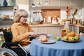 Senior woman cooking breakfast for herself Royalty Free Stock Photo