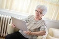 Senior woman using a wireless tablet at home Royalty Free Stock Photo