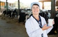 Senior woman veterinarian with milk on dairy farm Royalty Free Stock Photo