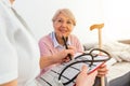 Senior woman is visited by her doctor or caregiver. Female doctor or nurse talking with senior patient. Medicine, age, health care Royalty Free Stock Photo