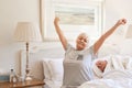 Senior woman waking up with a stretch in the morning Royalty Free Stock Photo