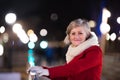 Senior woman on a walk in night city. Winter Royalty Free Stock Photo