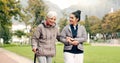 Senior woman, walker and nurse outdoor in a park with healthcare for elderly exercise. Walking, healthcare professional Royalty Free Stock Photo