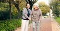 Senior woman, walker and nurse outdoor in a park with healthcare for elderly exercise. Walking, healthcare professional Royalty Free Stock Photo