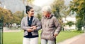 Senior woman, walker and nurse talking in a park with healthcare for elderly exercise. Walking, healthcare professional