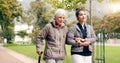 Senior woman, walker and nurse talking in a park with healthcare for elderly exercise. Walking, healthcare professional
