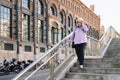 senior woman walking down stairs in the city Royalty Free Stock Photo