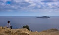 Senior woman watching the landscape of Tagomago Island from Punta Grossa in Cala de San Vicente, Ibiza