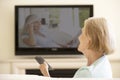 Senior Woman Watching Widescreen TV At Home Royalty Free Stock Photo