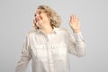 Senior woman waves her hand in disbelief Royalty Free Stock Photo