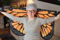 Senior woman waving butterfly wings Royalty Free Stock Photo