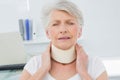 Senior woman wearing cervical collar in medical office Royalty Free Stock Photo