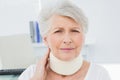 Senior woman wearing cervical collar in medical office Royalty Free Stock Photo