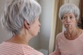 Senior woman wearing spooky vampire fangs Royalty Free Stock Photo