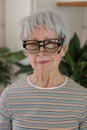 Senior woman wearing three eyeglasses simultaneously Royalty Free Stock Photo